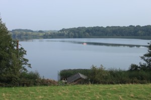 Figure 4 Rostherne Mere looking northwards with the boathouse in the foreground and the platform in the centre of the view.